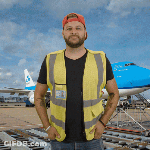 A Man Standing In Front Of A Klm Plane GIF