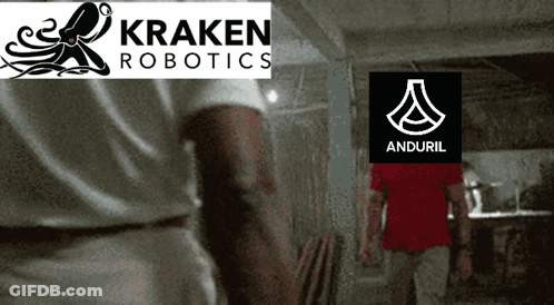 A Man Standing In Front Of A Kraken Robotics Logo And Anduril Logo GIF