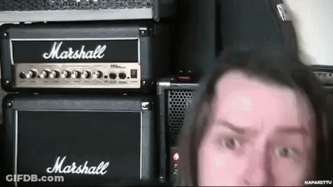 A Man Standing In Front Of A Marshall Amp GIF
