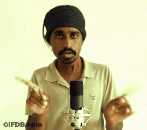 A Man Standing In Front Of A Microphone Wearing A Headband And A Shirt That Says ' Eagle ' On It GIF