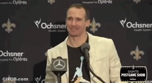 A Man Standing In Front Of A Microphone With His Arms Outstretched . GIF