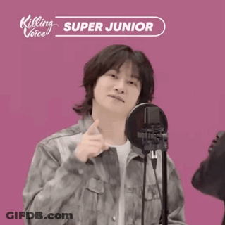 A Man Standing In Front Of A Microphone With Killing Voice Super Junior Written On It GIF