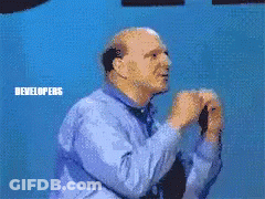A Man Standing In Front Of A Microsoft Windows Developers Sign GIF