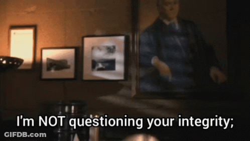 A Man Standing In Front Of A Mirror With The Words " I 'M Not Questioning Your Integrity " Below Him GIF
