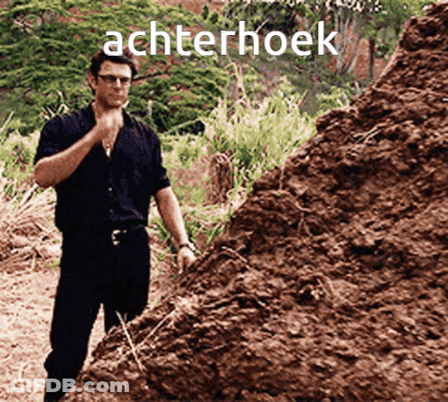 A Man Standing In Front Of A Pile Of Dirt With The Word Achterhoek Written On It GIF
