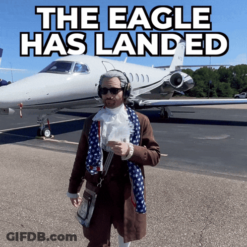 A Man Standing In Front Of A Plane That Says The Eagle Has Landed On It GIF