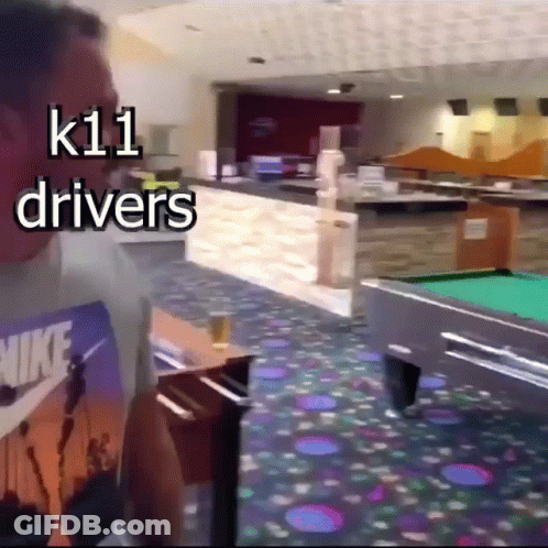 A Man Standing In Front Of A Pool Table With The Words K11 Drivers Above Him GIF