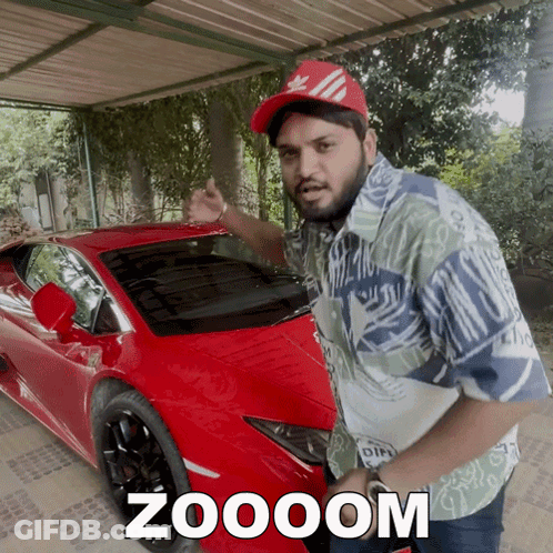 A Man Standing In Front Of A Red Car With Zoooom Written On It GIF