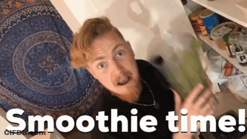 A Man Standing In Front Of A Shelf With The Words Smoothie Time Written Below Him GIF