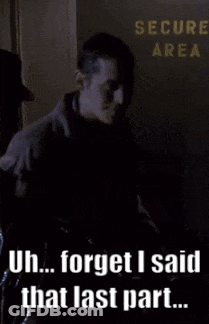 A Man Standing In Front Of A Sign That Says " Secure Area " GIF