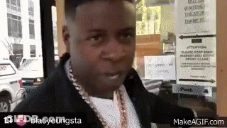 A Man Standing In Front Of A Sign That Says Waiting GIF
