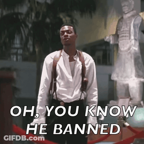 A Man Standing In Front Of A Statue With The Words Oh You Know He Banned On The Bottom GIF