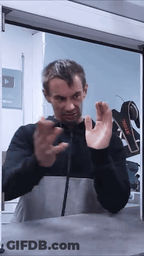 A Man Standing In Front Of A Stihl Sign GIF