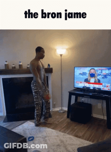 A Man Standing In Front Of A Television With The Words The Bron Jamie On The Bottom GIF