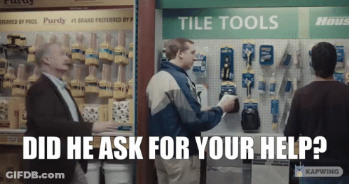 A Man Standing In Front Of A Tile Tools Display Asks For Help GIF