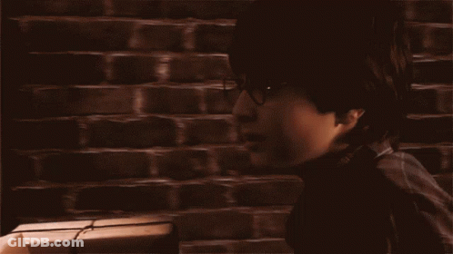 A Man Standing In Front Of A Train With The Words Back To Hogwarts Written On The Bottom GIF