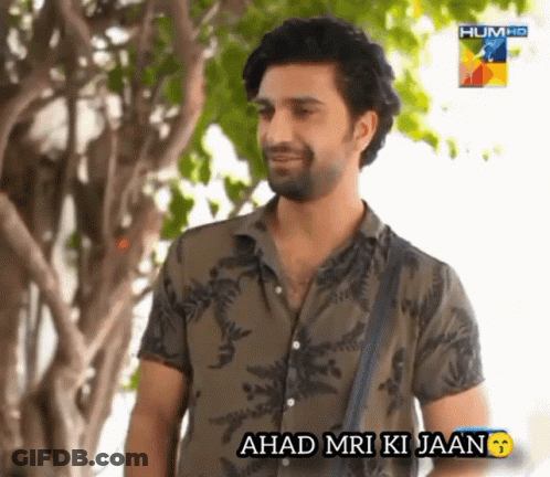 A Man Standing In Front Of A Tree With The Words ' Ahad Mri Ki Jaan ' Below Him GIF