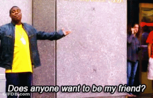 A Man Standing In Front Of A Wall With The Words " Does Anyone Want To Be My Friend " GIF