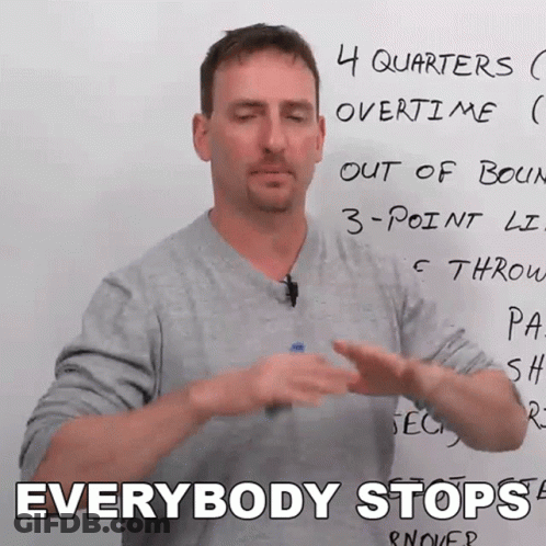 A Man Standing In Front Of A White Board With The Words Everybody Stops Written On It GIF