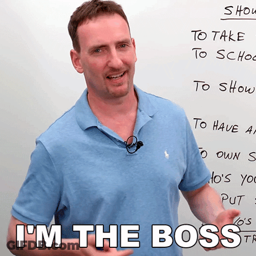 A Man Standing In Front Of A White Board With The Words I 'M The Boss Written On It GIF