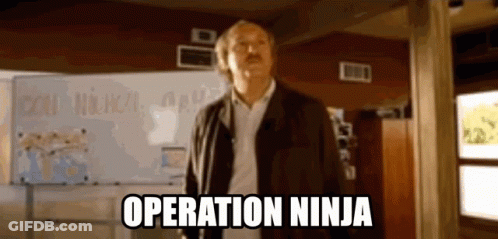 A Man Standing In Front Of A White Board With The Words Operation Ninja On It GIF