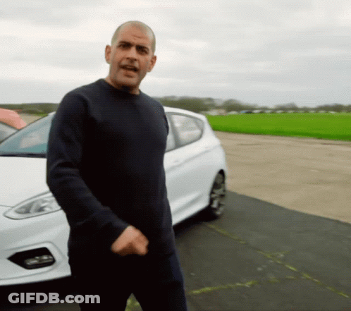 A Man Standing In Front Of A White Car GIF