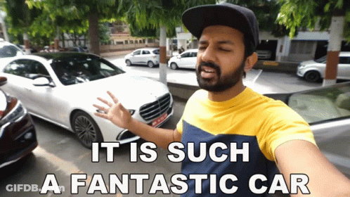 A Man Standing In Front Of A White Car With The Words " It Is Such A Fantastic Car " Below Him GIF