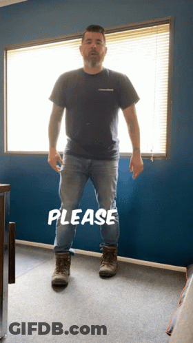 A Man Standing In Front Of A Window With The Word Please Written On The Floor GIF