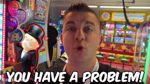 A Man Standing In Front Of An Arcade Machine With The Words " You Have A Problem " On The Bottom GIF