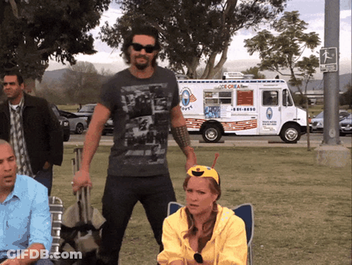A Man Standing In Front Of An Ice Cream Truck That Says Ice Cream GIF