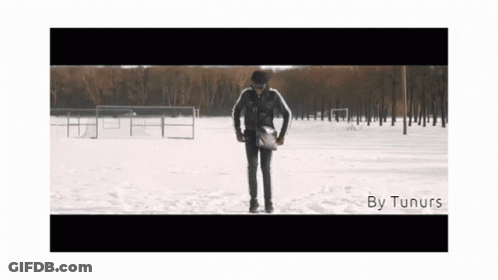 A Man Standing In The Snow With The Words By Tunurs On The Bottom Right GIF