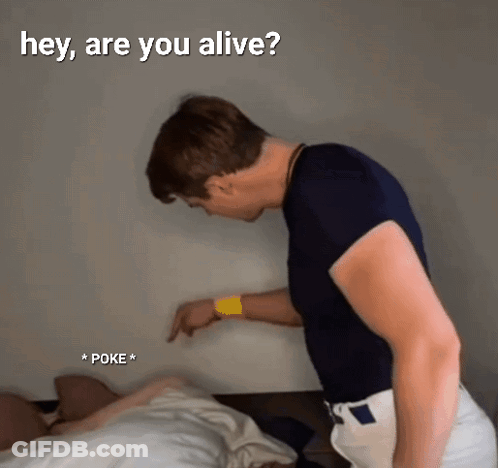 A Man Standing Next To A Bed With The Words " Hey Are You Alive " On The Bottom GIF