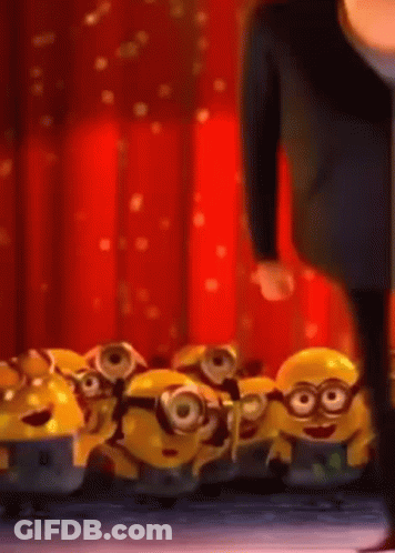 A Man Standing Next To A Bunch Of Minions GIF
