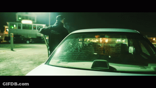 A Man Standing Next To A Car That Has A Sticker On The Windshield That Says ' Ambulance ' GIF