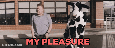 A Man Standing Next To A Cow Costume That Says " My Pleasure " GIF