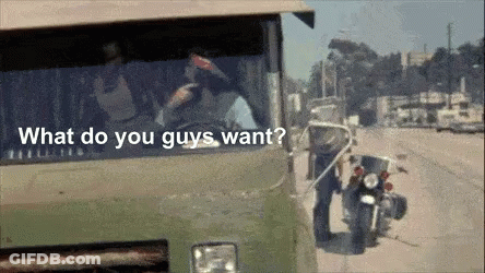 A Man Standing Next To A Motorcycle With The Words " What Do You Guys Want " On The Bottom GIF