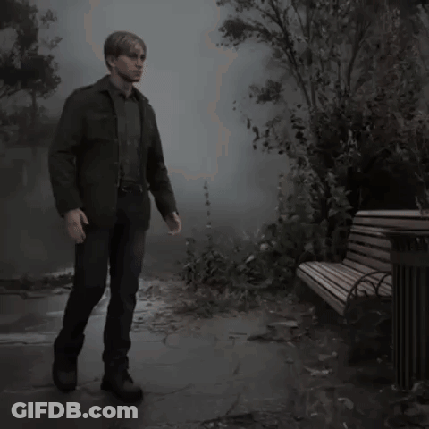 A Man Standing Next To A Park Bench In The Fog GIF