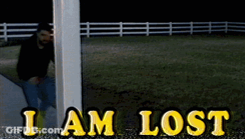 A Man Standing Next To A Pole With The Words I Am Lost In Yellow Letters GIF