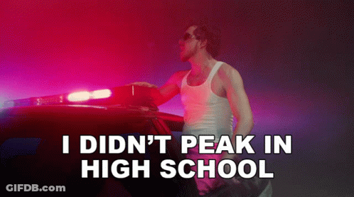 A Man Standing Next To A Police Car With The Words " I Did N't Peak In High School " On The Bottom GIF