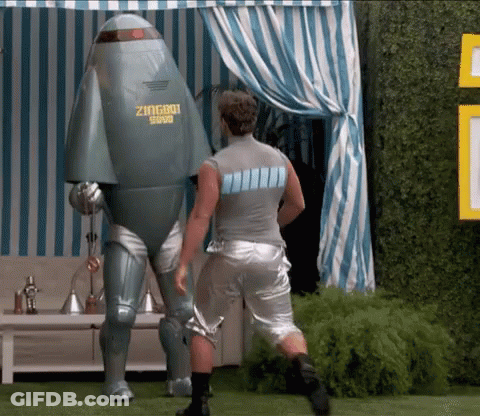 A Man Standing Next To A Robot That Says Zingbot GIF