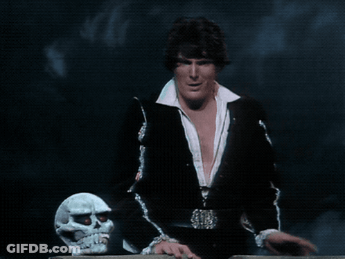 A Man Standing Next To A Skull With The Words Hamlet Does N't Sing GIF