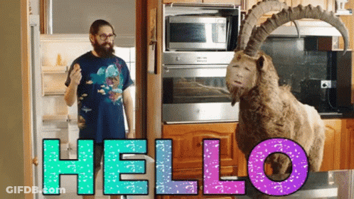 Man Next To Stuffed Goat Saying Hello GIF