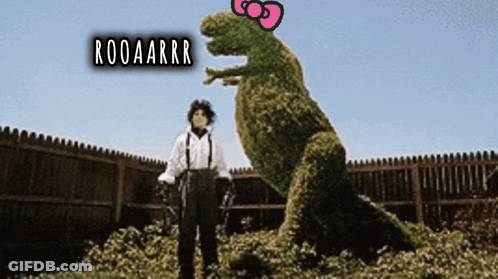 A Man Standing Next To A T-Rex With The Words Rooaarrr On The Top GIF