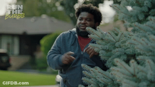 A Man Standing Next To A Tree With The Words Run The Burbs Written On The Bottom GIF