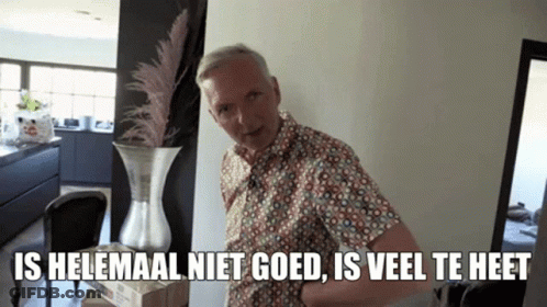 A Man Standing Next To A Vase With The Words Is Helemaal Niet Goed Is Veel Te Heet Written Below Him GIF