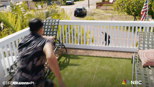 A Man Standing On A Balcony With The Nbc Logo On The Bottom Right GIF