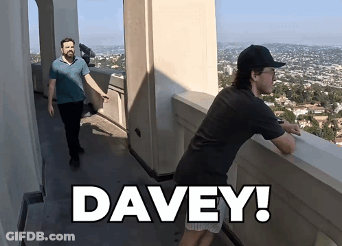A Man Standing On A Balcony With The Word Davey On The Bottom Right GIF