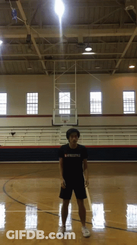 A Man Standing On A Basketball Court Wearing A Freestyle Shirt GIF