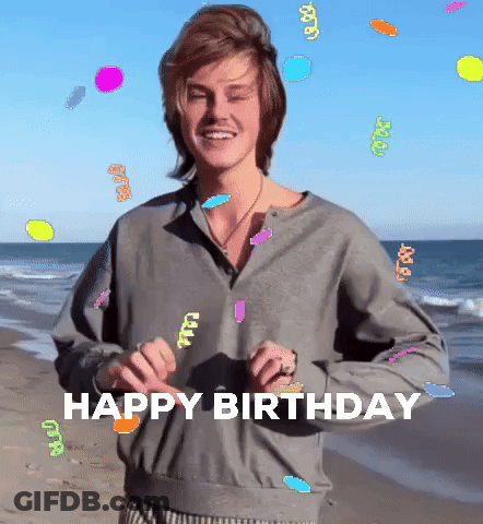 A Man Standing On A Beach With The Words Happy Birthday Written On It GIF