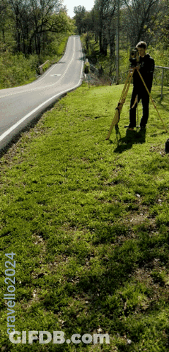 A Man Standing On A Grassy Hill Next To A Road With The Words Gravelozzi24 Written On The Bottom GIF